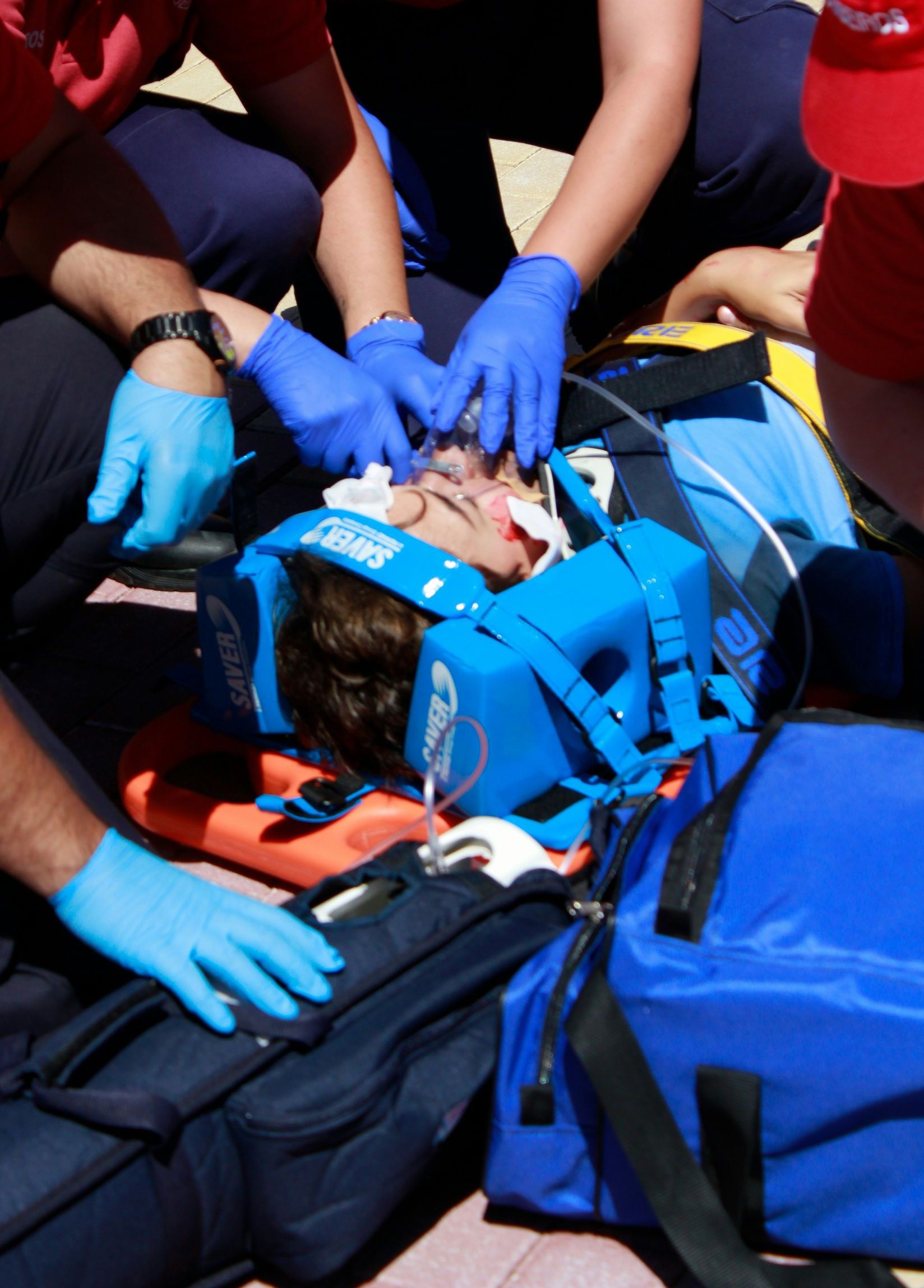 people performing first aid medical care to an injured man